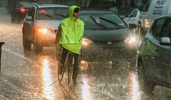 Clayton Adams rides 2 miles every day rain or shine. He was at Edgewood Avenue and Boulevard Wednesday. JOHN SPINK / JSPINK@AJC.COM