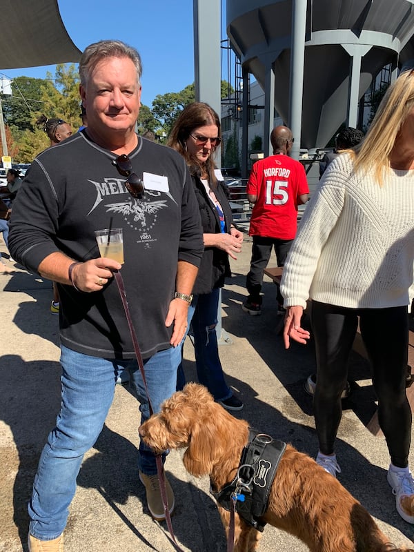 Afternoon host Mike Bell with his dog at the 92.9/The Game 10th anniversary party at New Realm Brewery in Atlanta October 22, 2022. RODNEY HO/rho@ajc.com