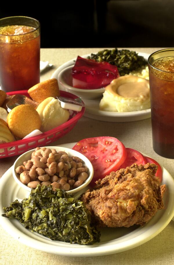 Fried chicken, greens, tomato slices and pinto beans and mashed potatoes, jello, greens and fresh corn served with sweet tea and bread at Silver Grill. / File photo