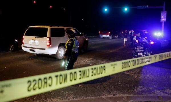 Police continue to restrict access to the neighborhood at the site of Sunday's explosion, early Monday, March 19, 2018, in Austin, Texas. Multiple people were injured in the explosion Sunday night, and police warned nearby residents to remain indoors overnight as investigators looked for possible links to other package bombings elsewhere in the city this month. (AP Photo/Eric Gay)