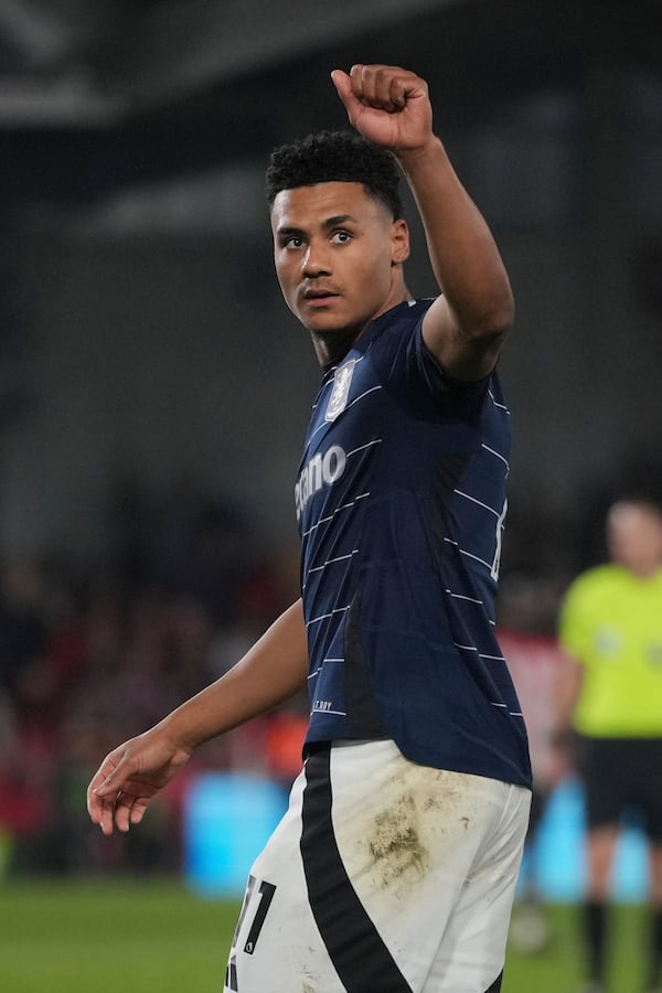 Aston Villa's Ollie Watkins celebrates towards his side fans after scoring the opening goal during the English Premier League soccer match between Brentford and Aston Villa at the Gtech Community stadium in London, Saturday, March 8, 2025. (AP Photo/Kin Cheung)