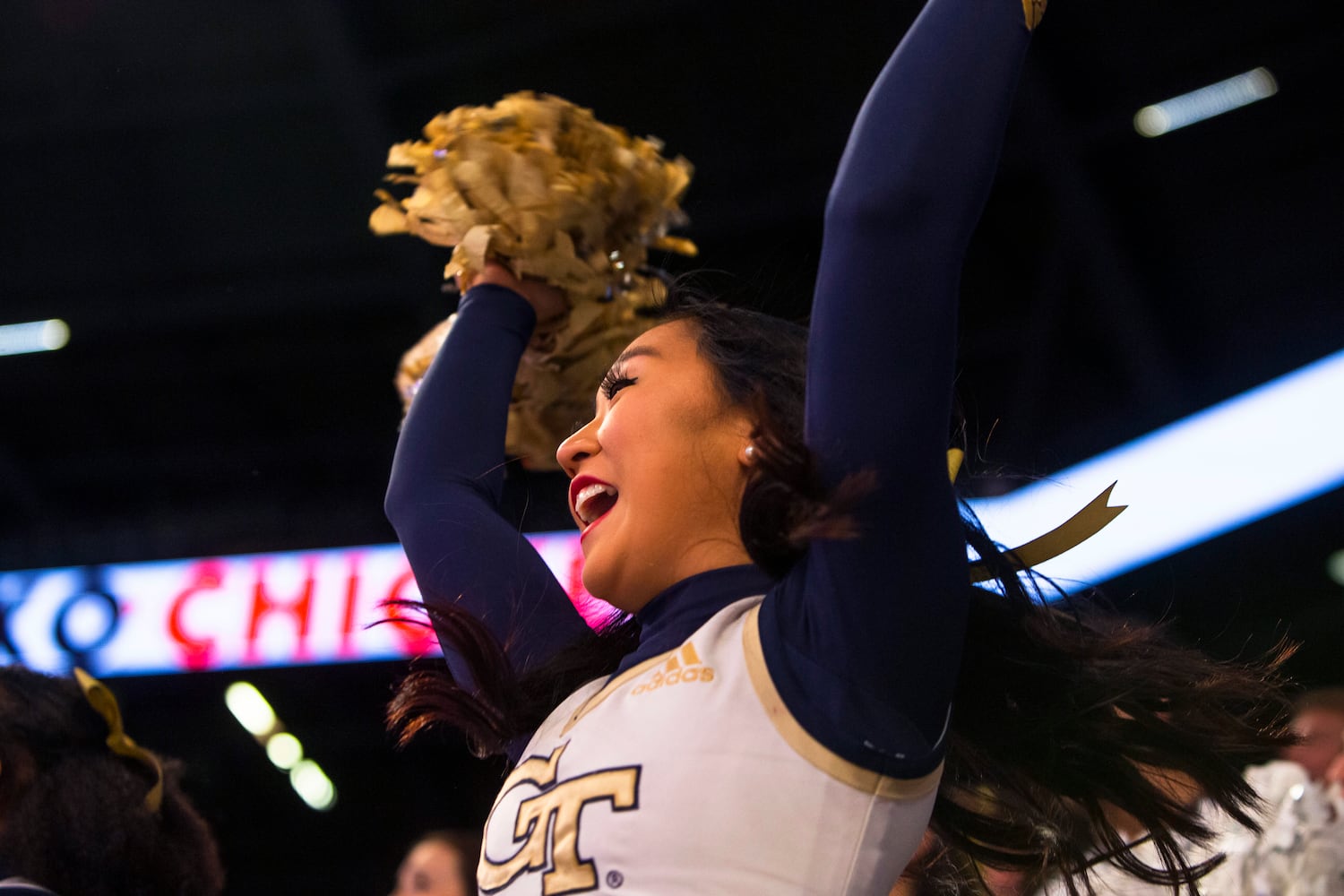 A Georgia Tech cheerleader encourages the Yellow Jackets during a women's basketball game against the rival Bulldogs on Sunday in Atlanta. Georgia defeated Georgia Tech 66-52. (CHRISTINA MATACOTTA / FOR THE ATLANTA JOURNAL-CONSTITUTION)