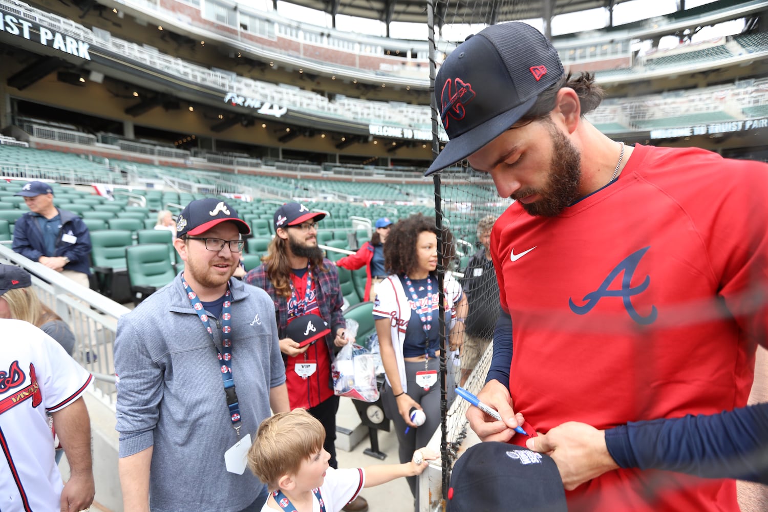 Braves shortstop Dansby Swanson signs autographs before the game Monday at Truist Park. (Miguel Martinez/miguel.martinezjimenez@ajc.com)