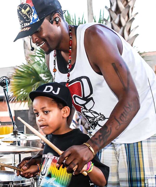 JFly gives a 5-year-old student artist some quick tips during soundcheck at the JFly Music Festival. CONTRIBUTED