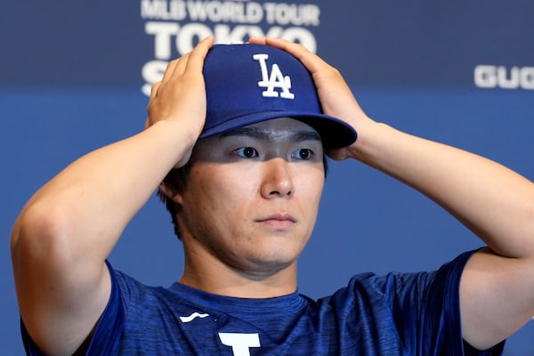 Los Angeles Dodgers pitcher Yoshinobu Yamamoto attends the official Press conference Friday, March 14, 2025, in Tokyo, as the Dodgers play their MLB opening games against the Chicago Cubs at Tokyo Dome next week. (AP Photo/Eugene Hoshiko)