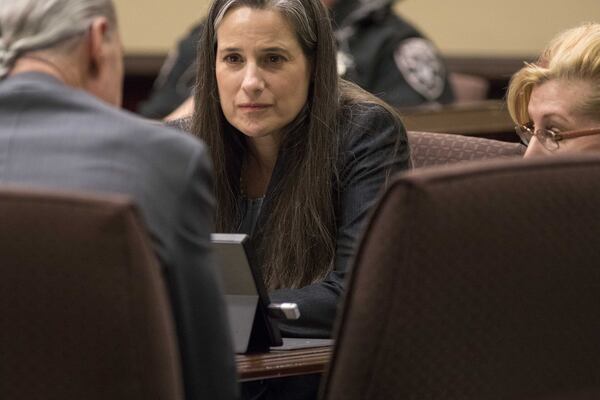 Nydia Tisdale sits with her lawyers during a trial at the Dawson Superior Court, Thursday, Nov. 30, 2017. ALYSSA POINTER / ALYSSA.POINTER@AJC.COM