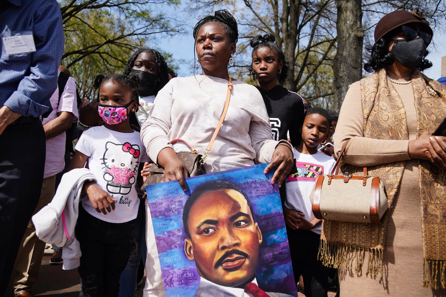 Margo Gibson-Brown, of Marietta, center, and her children, from left, Jayme Gibson-Brown, 6, Journee Gibson-Brown, and Jordan Gibson-Brown, 7, listen to a speaker at a wreath laying ceremony at The King Center on the 54th anniversary of the assassination of Dr. Martin Luther King Jr., on Monday, April 4, 2022, in Atlanta. (Elijah Nouvelage/Special to the Atlanta Journal-Constitution)