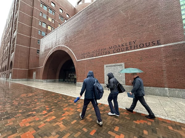 People walk past the the John Joseph Moakley United States Courthouse in Boston, Monday, March 17, 2025. (AP Photo/Charles Krupa)