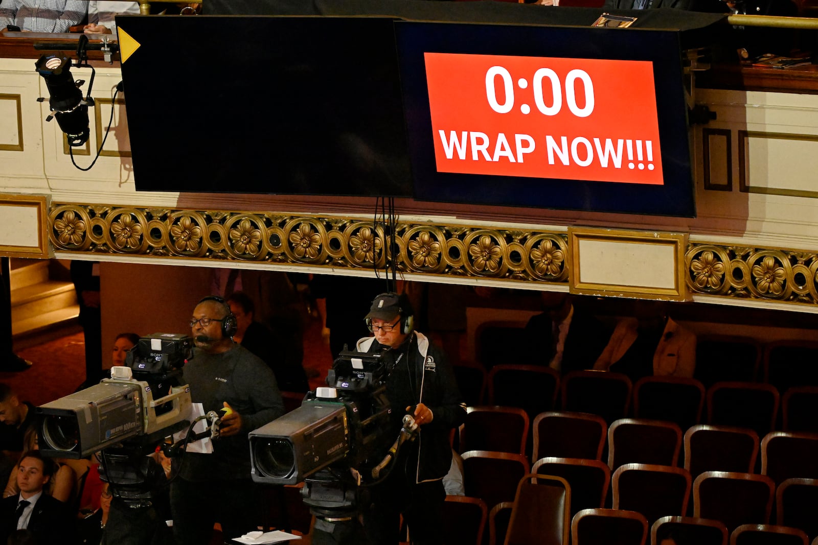 A sign flashes to wrap now as Doug Collins speaks during his enshrinement in the Basketball Hall of Fame, Sunday Oct. 13, 2024, in Springfield, Mass. (AP Photo/Jessica Hill)