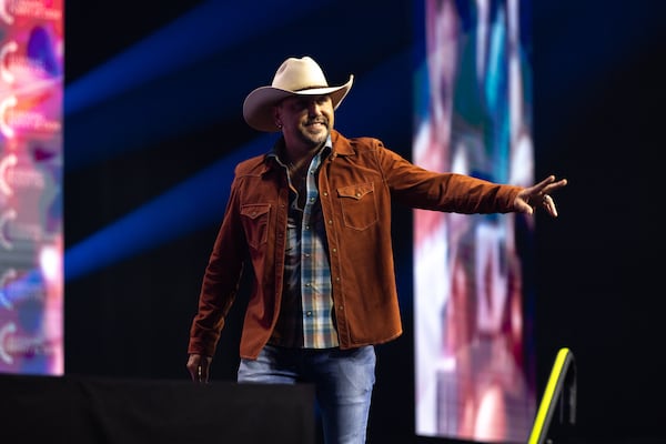 Country singer Jason Aldean leaves the stage after speaking during a campaign rally for former President Donald Trump in Duluth on Wednesday.