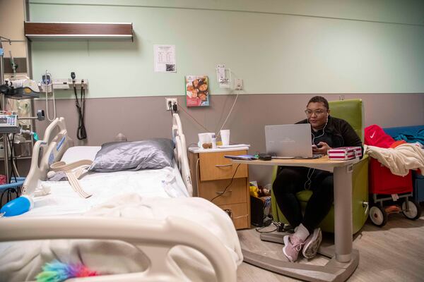 DeKalb County School District teacher Jasmine Casilla interacts with students during online learning from her daughter’s hospital room at the Children’s Healthcare of Atlanta - Egleston Hospital in Atlanta, Jan.  29, 2021. (Alyssa Pointer / Alyssa.Pointer@ajc.com)