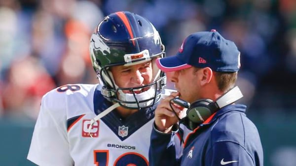 ADVANCE FOR WEEKEND EDITIONS, DEC. 20-21- FILE - In this Oct. 12, 2014, file photo, Denver Broncos quarterback Peyton Manning (18) talks with offensive coordinator Adam Gase between plays during the third quarter of an NFL football game against the New York Jets in East Rutherford, N.J. The Associated Press will honor an NFL assistant coach for the first time this year with his own award. (AP Photo/Kathy Willens, File) Denver Broncos quarterback Peyton Manning (18) talks with offensive coordinator Adam Gase between plays during the third quarter of an NFL football game against the New York Jets in East Rutherford, N.J. He was interview by the Falcons on Friday. (AP Photo/Kathy Willens, File)