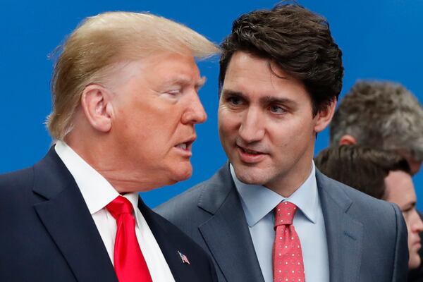 FILE - U.S. President Donald Trump, left, and Canadian Prime Minister Justin Trudeau talk prior to a NATO round table meeting at The Grove hotel and resort in Watford, Hertfordshire, England, Dec. 4, 2019. (AP Photo/Frank Augstein, File)