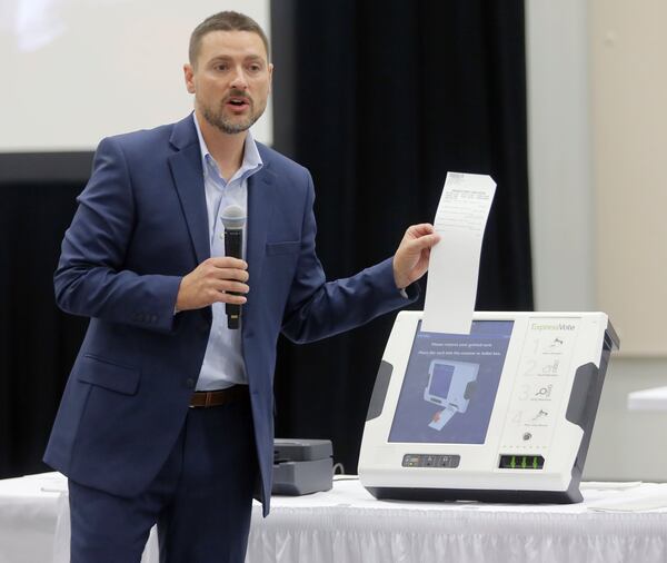 Jeb Cameron from Election Systems & Software shows the printed tally from his company’s ballot-marking voting system. Voting machine companies demonstrated their products Aug. 30 at the second meeting of the Secure, Accessible & Fair Elections Commission, which is evaluating whether to switch from electronic voting machines to ones that offer paper ballots for verification and auditing. Vendors present included Clear Ballot, Unisyn Voting Solutions, Smartmatic, Election Systems & Software, Hart InterCivic and Dominion Voting. BOB ANDRES /BANDRES@AJC.COM