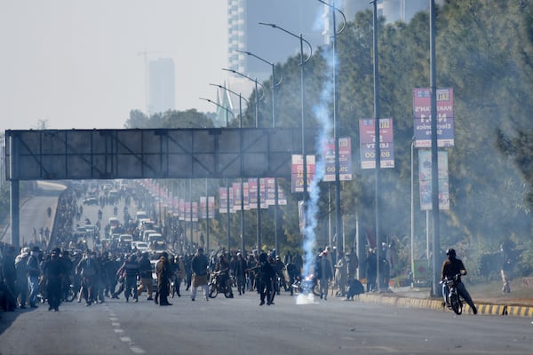 Police fire tear gas to disperse supporters of imprisoned former premier Imran Khan's Pakistan Tehreek-e-Insaf party, at D-Chowk square close to Red Zone, which is an area that houses key government buildings, in Islamabad, Pakistan, Tuesday, Nov. 26, 2024. (AP Photo/W.K. Yousufzai)