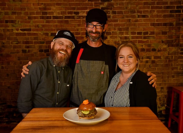 The crew at Local Republic — (from left) Kevin Pearson (general manager), chef Brian Hill, and Taylor Smith (front of the house manager) — share a midafternoon laugh. They're shown with Local Republic's Pepper Jack Loves Fraggle Rock Smash Burger. (Styling by chef Brian Hill / Chris Hunt for the AJC)