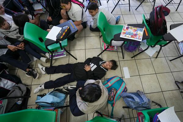 Students participate in an active shooter drill at the Socrates elementary school in Culiacan, Mexico, Thursday, Feb. 27, 2025. (AP Photo/Fernando Llano)