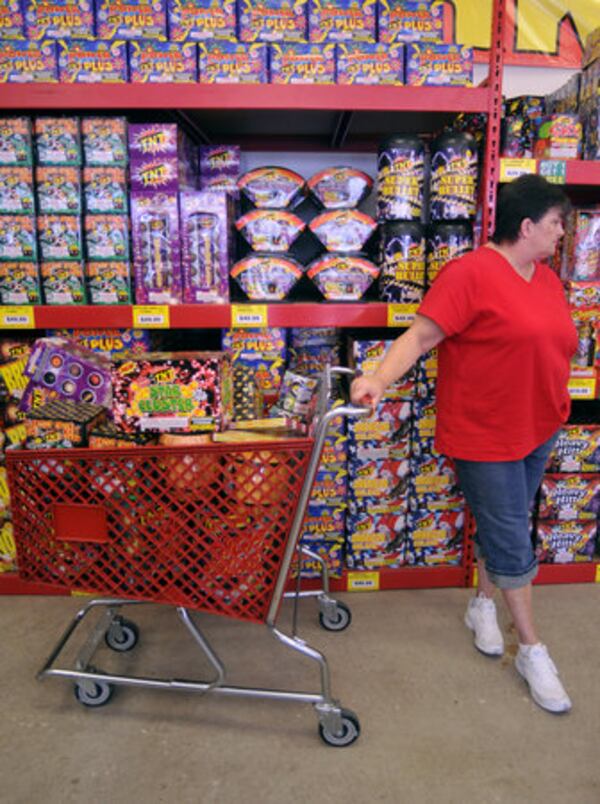 Judy Egelston of Middletown waits for her husband with their fireworks at TNT Fireworks. "He's like a kid in a candy store," she said, as he goes to get more fireworks before they check out.