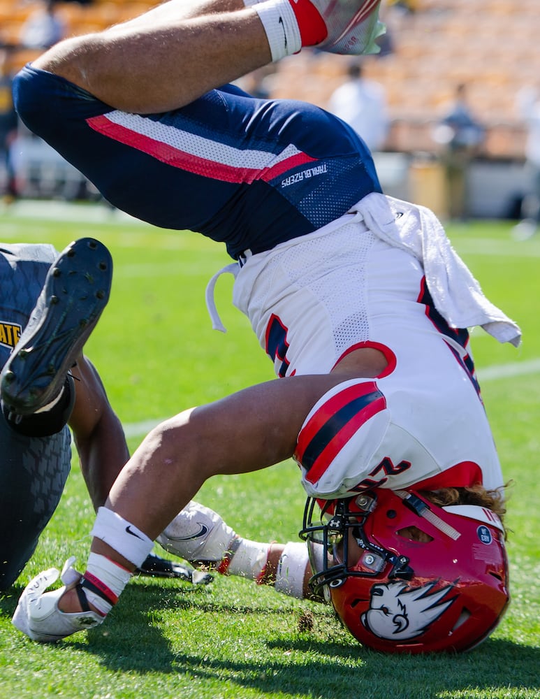 Brian Davison of Dixie State rolls on his head after making a tackle. CHRISTINA MATACOTTA FOR THE ATLANTA JOURNAL-CONSTITUTION.