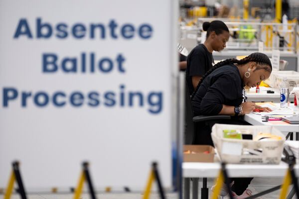 Workers at the Fulton County election hub in Fairburn process absentee ballots Monday, Nov. 4, 2024.   Ben Gray for the Atlanta Journal-Constitution