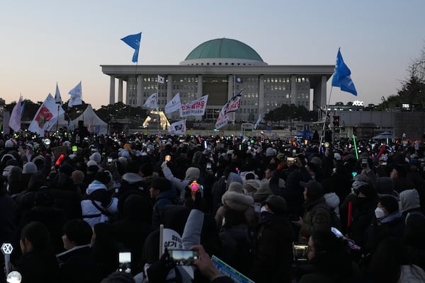 FILE - Participants react after hearing the news that South Korea's parliament voted to impeach President Yoon Suk Yeol outside the National Assembly in Seoul, South Korea, on Dec. 14, 2024. (AP Photo/Lee Jin-man, File)