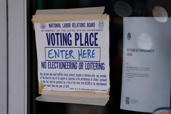 A union voting place sign is taped to the entrance of Starbucks at Ansley Mall where employees on Wednesday voted to unionize. (Natrice Miller / natrice.miller@ajc.com)