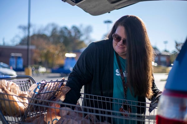 Shopper April Wright loads groceries into her car for a customer in Canton. Wright has been working with shop-and-deliver company Shipt for almost 3 years. The coronavirus pandemic caused a massive surge in online grocery shopping.  (Alyssa Pointer / Alyssa.Pointer@ajc.com)