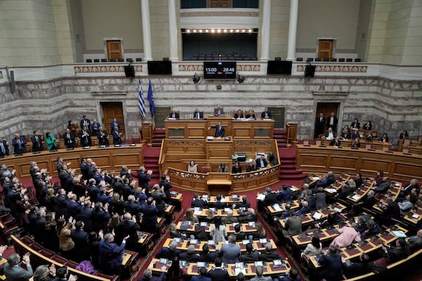 Lawmakers of the New Democracy ruling party applaud Greek Prime Minister Kyriakos Mitsotakis during his speech in parliament ahead of the submission of a no-confidence motion by opposition parties over the government's handling of Greece's worst rail disaster two year ago, in Athens, Wednesday, March 5, 2025. (AP Photo/Thanassis Stavrakis)