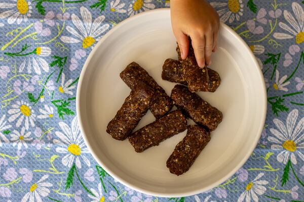 The easiest snack bars to make at home are ones made with a combination of dried fruit and nuts, such as the Cherry and Walnut Snack Bars pictured here. (Kate Williams for The Atlanta Journal-Constitution)