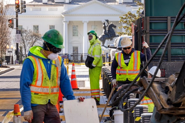 With the White House in the background, a worker watches as demolition begins on the Black Lives Matter mural, Monday, March 10, 2025, in Washington. (AP Photo/Jacquelyn Martin)