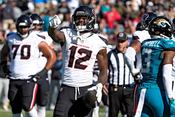 Houston Texans wide receiver Nico Collins (12) reacts after the Jacksonville Jaguars were called for a penalty during the first half of an NFL football game Sunday, Dec. 1, 2024, in Jacksonville, Fla. (AP Photo/John Raoux)