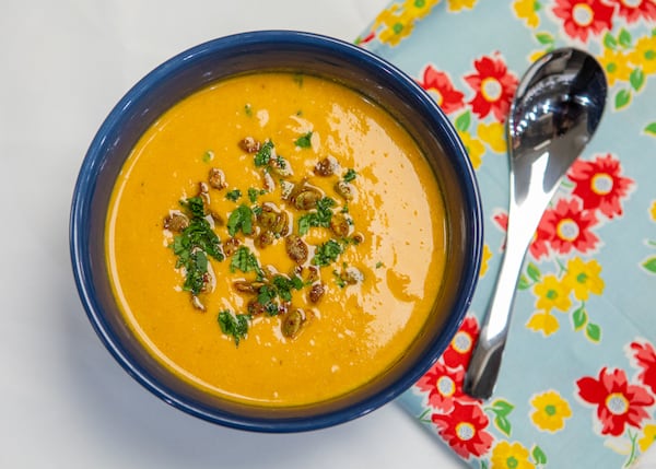 Nancy Rinehart of Side Hustle Soups adapted her Thai chicken soup recipe into a vegan version that features pumpkin puree and roasted, seasoned pumpkin seeds. (Aaliyah Man for The Atlanta Journal-Constitution)