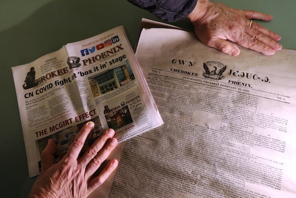 John Perry looks over a copy of the first Native American newspaper the Cherokee Phoenix Volume 1, No. 1, printed Feb 21, 1828, and a recent copy of the newspaper printed Oct. 15, 2020, at New Echota Historic Site on Tuesday, Dec. 8, 2020, in Calhoun. Curtis Compton / Curtis.Compton@ajc.com