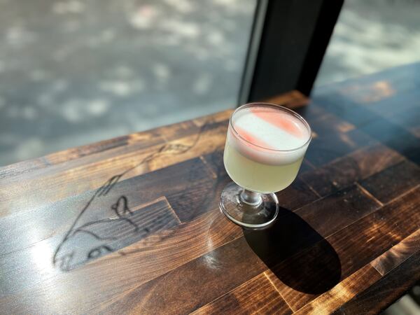 Classic Pisco Sour from Tio Lucho's made with pisco, eau de vie, egg white, lime, peychaud flag.