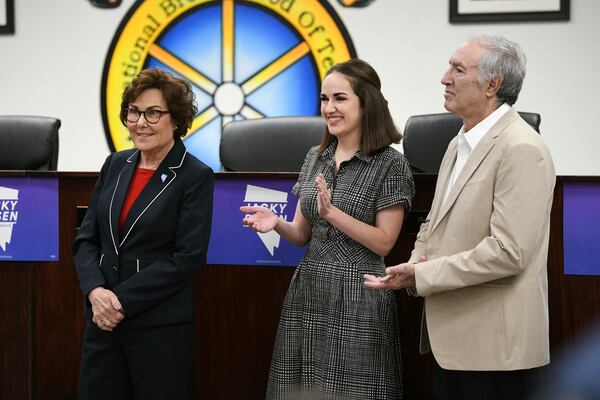 Sen. Jacky Rosen, D-Nev., is applauded by her daughter Miranda Rosen, center, and husband Larry Rosen before delivering remarks after winning re-election Saturday, Nov. 9, 2024, in Las Vegas. (Sam Morris/Las Vegas Review-Journal via AP)