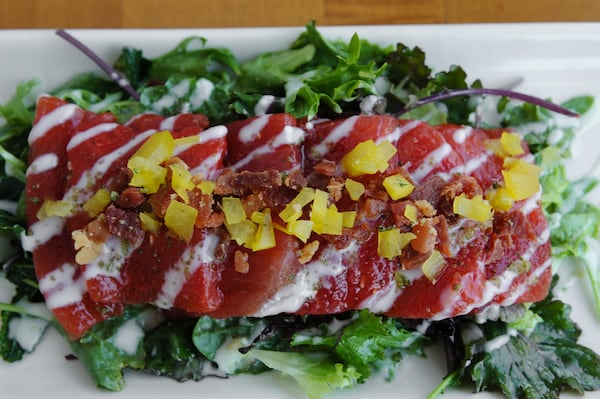 Watermelon Salad over spicy arugula with honey yogurt dressing, topped with country ham and candied basil. (BECKY STEIN PHOTOGRAPHY)