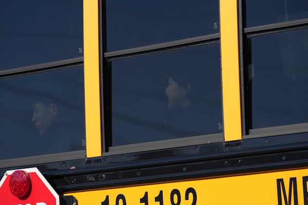 A school bus arrives at unification site following a shooting at the Antioch High School in Nashville, Tenn., Wednesday, Jan. 22, 2025. (AP Photo/George Walker IV)