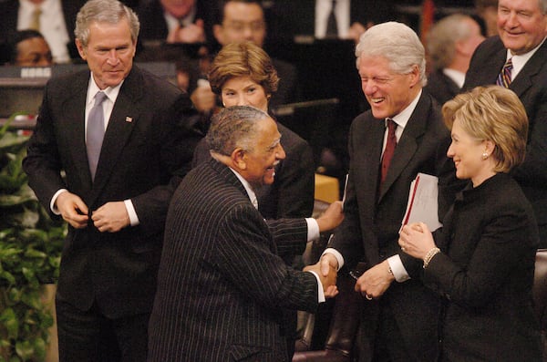 060207 - LITHONIA, GA -- The funeral service for Coretta Scott King, wife of Dr. Martin Luther King, Jr., was held Tuesday, Feb. 7, 2006 at the New Birth Missionary Baptist Church. Rev. Joseph Lowery (cq) gets a laugh from former President Bill Clinton and his wife, Sen. Hillary Clinton, after he honored King. Left is Pres. George Bush and his wife, Laura. (RENEE HANNANS HENRY/AJC staff)