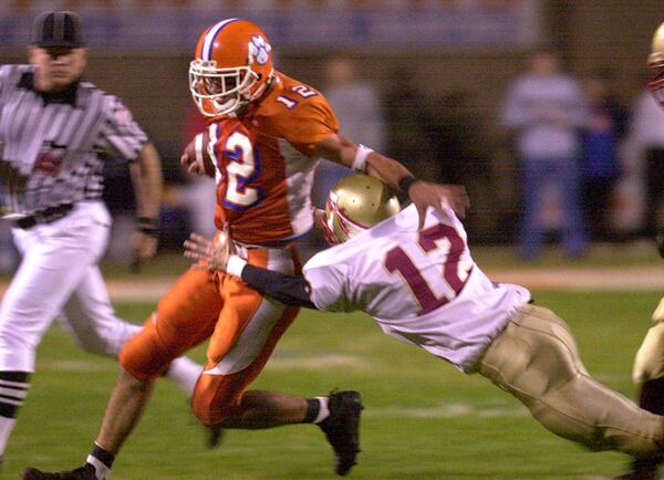 Parkview's Jeff Francoeur(12) gives a stiff-arm to Westside Macon defender John Clark in 2001 quarterfinal playoff action. Parkview 35-6 won to advance to the semifinals.