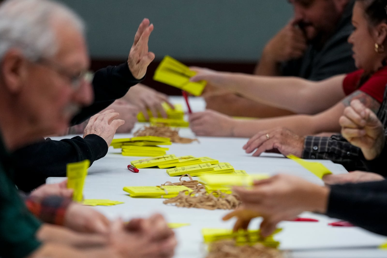 Volunteers tally votes on a new contract offer from Boeing, Wednesday, Oct. 23, 2024, at Seattle Union Hall in Seattle. (AP Photo/Lindsey Wasson)