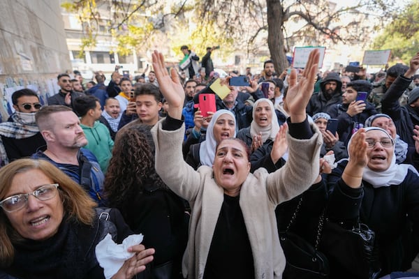 Mourners, including his sister Amal, left, attend the funeral of Syrian activist Mazen al-Hamada in Damascus Thursday Dec. 12, 2024. Al-Hamad's mangled corpse was found wrapped in a bloody sheet in Saydnaya prison. He had fled to Europe but returned to Syria in 2020 and was imprisoned upon arrival. (AP Photo/Hussein Malla)