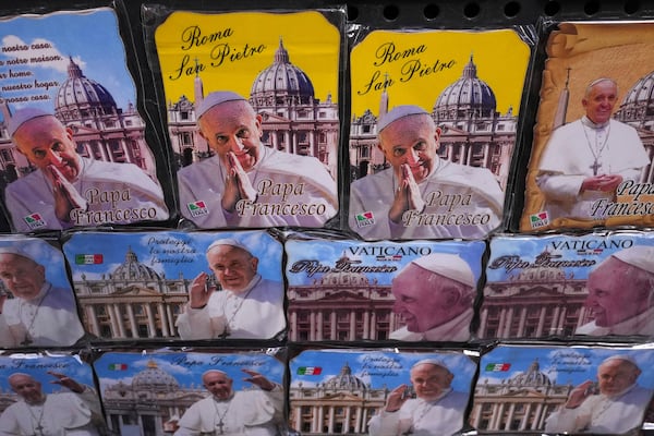 Magnets showing Pope Francis are displayed outside a souvenir shop in Rome, Thursday, Feb. 27, 2025. (AP Photo/Kirsty Wigglesworth)