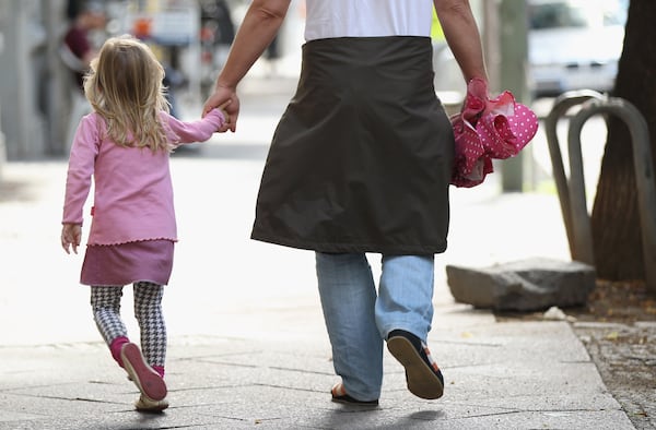 A father and daughter walk in the city center on July 17, 2012 in Berlin, Germany.