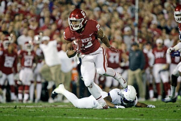 NORMAN, OK - NOVEMBER 11: Running back Rodney Anderson #24 of the Oklahoma Sooners sheds a tackle on his way to score against the TCU Horned Frogs at Gaylord Family Oklahoma Memorial Stadium on November 11, 2017 in Norman, Oklahoma. (Photo by Brett Deering/Getty Images)