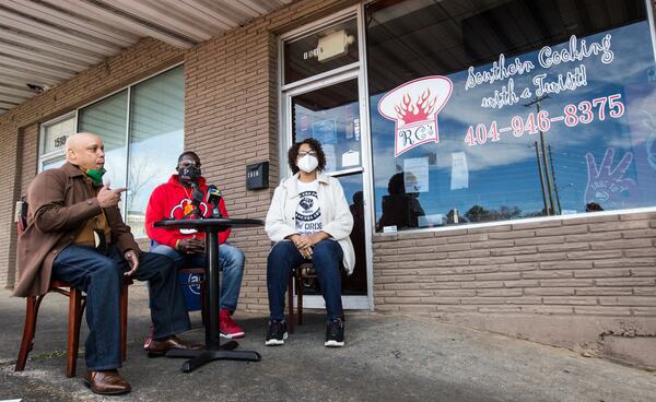 Outside Renardo Lewis' restaurant in Marietta, Gerald Rose with New Order National Human Rights Organization, left, is with Renardo Lewis, center, and Kymberly Hartfield, right, the New Order national field director, Tuesday, Dec 15, 2020. Lewis was charged with assaulting a police office in March 2019 and now, at the request of Cobb County prosecutors, a judge signed an order dropping all charges.  (Jenni Girtman for Atlanta Journal Constitution)