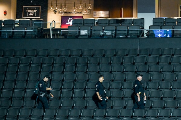 
Law enforcement officers survey the Fiserv Forum in Milwaukee, the site of the Republican National Convention, on July 14, 2024. Attendees at the Republican National Convention in Milwaukee this week will notice a very heavy police presence, said Anthony Gugliemi, a spokesman for the Secret Service. (Kenny Holston/The New York Times)
                      