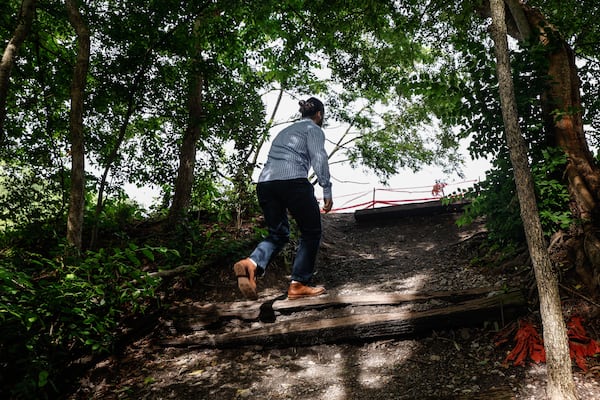 Portman Vice President of Development Mike Greene walks up a path from Amsterdam Walk to the transit corridor  near Beltline construction on Friday, May 10, 2024. (Natrice Miller/ AJC)