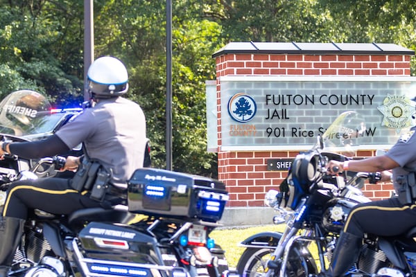 Sheriff’s deputies ride past the Fulton County Jail in Atlanta on Tuesday, August 22, 2023. (Arvin Temkar / arvin.temkar@ajc.com)