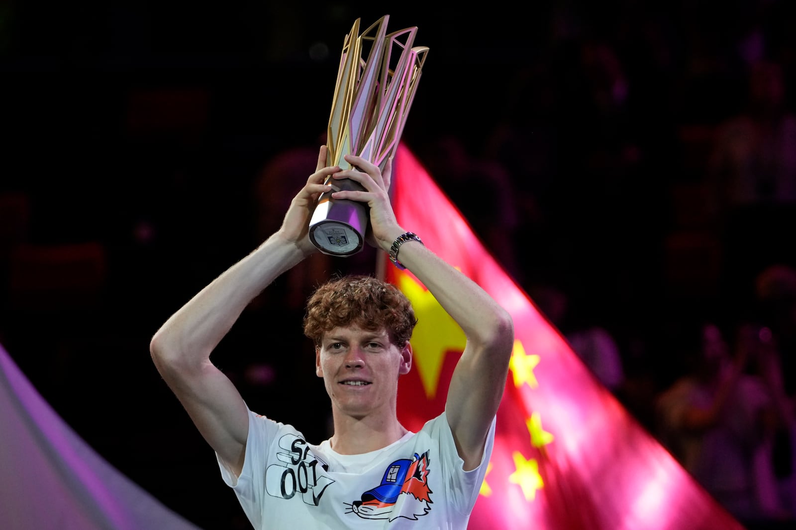 Jannik Sinner of Italy celebrates with his trophy after defeating Novak Djokovic of Serbia in the men's singles finals match for the Shanghai Masters tennis tournament at Qizhong Forest Sports City Tennis Center in Shanghai, China, Sunday, Oct. 13, 2024. (AP Photo/Andy Wong)