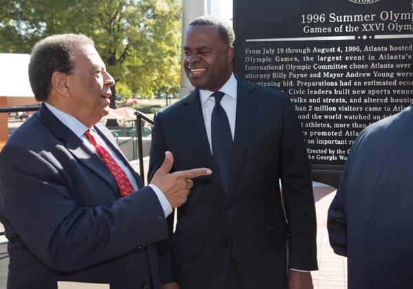 Ambassador Andrew Young (left) and Mayor Kasim Reed chat after the dedication of a Georgia Historical Marker to the 1996 Summer Olympic Games in Centennial Olympic Park in Atlanta on Tuesday, Nov. 1, 2016. An effort of the Georgia Historical Society, the dedication took place as the organization inducts the Georgia World Congress Center Authority as an honoree in its Georgia Business History Initiative. (AJC)